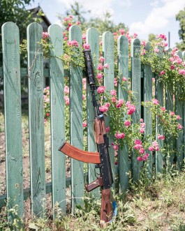 Vova's AK74 leans against a fence